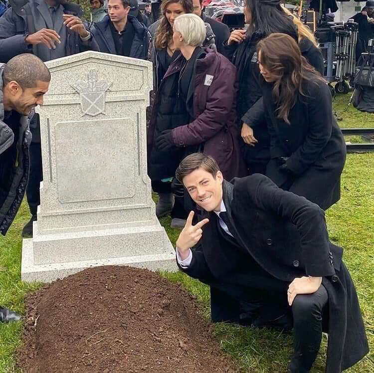 Guy posing in front of grave