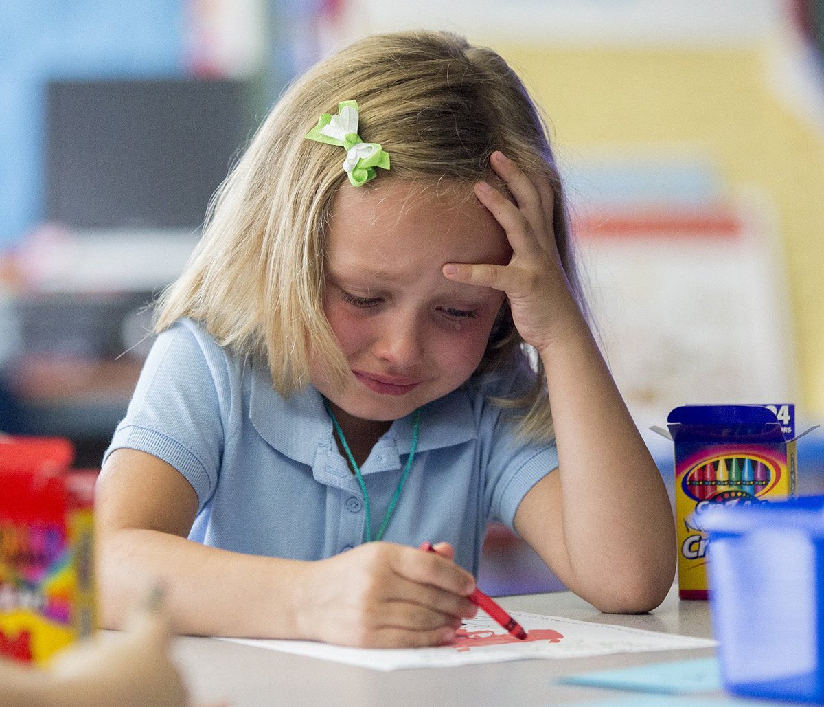 Girl crying while drawing