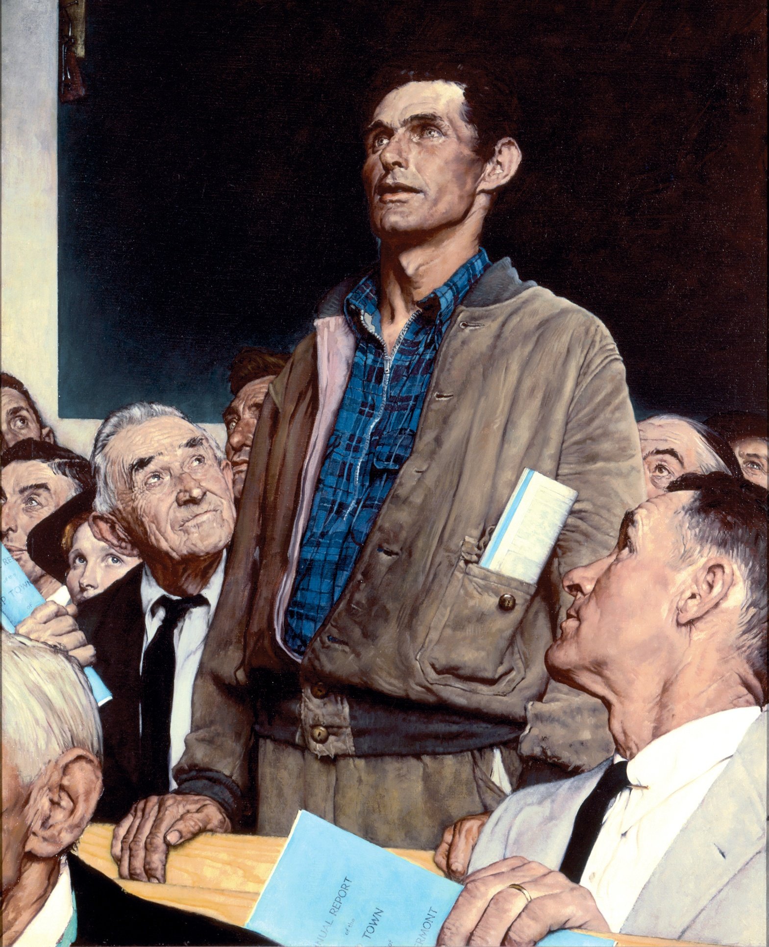 man taking a stand in a town hall meeting